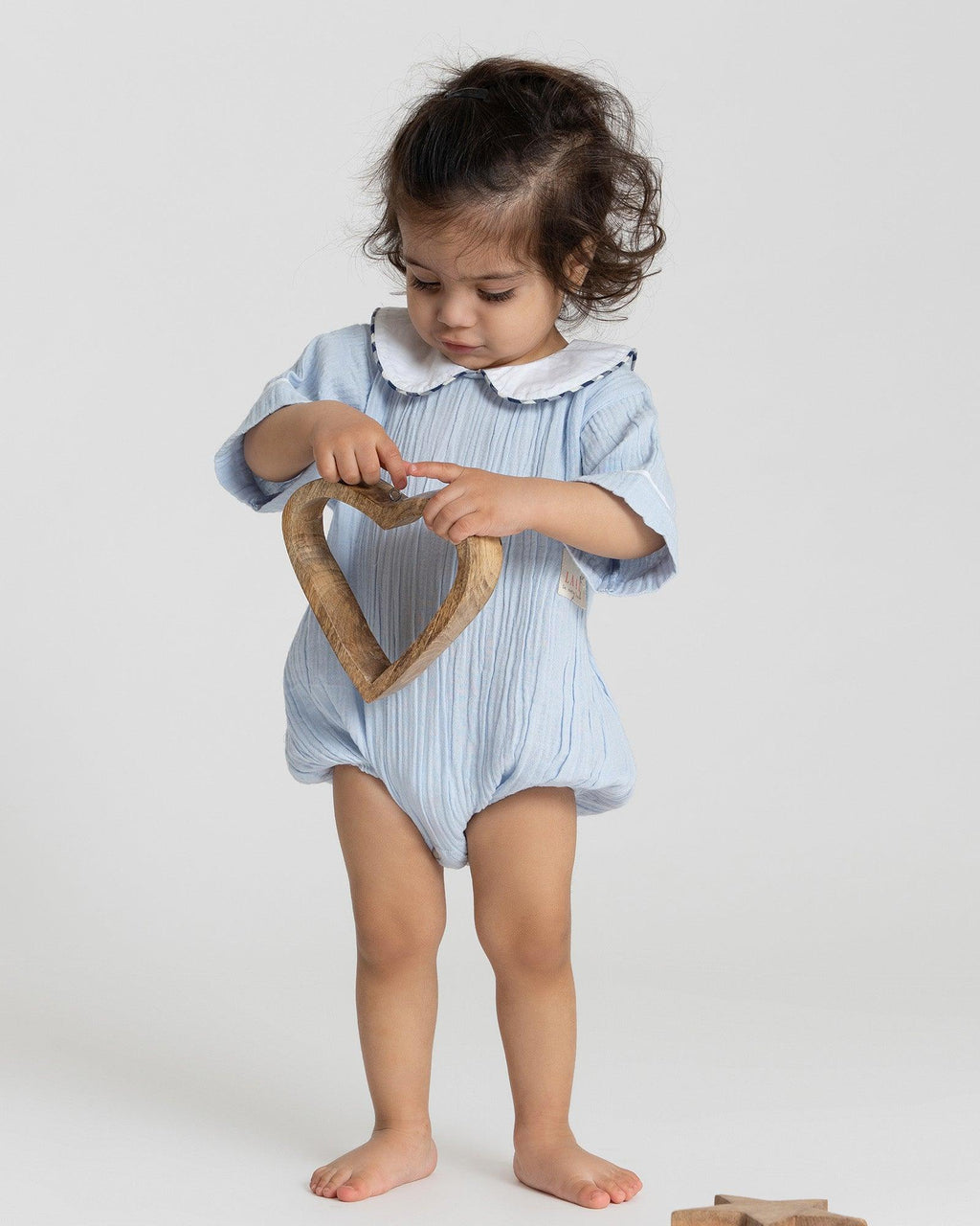 LAAD `S toddler is wearing  a cute white collar & refreshing blue romper perfect for summer. 