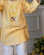 Elegant yellow kurta pyjama set for kids by Laad India, featuring delicate beadwork, intricate hand embroidery of a bambi, and a soft cotton lining for ultimate comfort. Perfect ethnic wear for festive occasions and celebrations