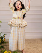 Adorable girls' yellow checkered co-ord set by Laad India, featuring intricate floral and animal embroidery, ruffled peplum top, and comfortable wide-leg pants. A perfect blend of vintage charm and modern elegance for your little one."