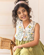LAAD`S kid in Titalee moss green dress by Laad India, featuring delicate floral embroidery, an eyelet lace bodice, and a gingham checkered dress. A perfect blend of vintage elegance and modern comfort for your little one