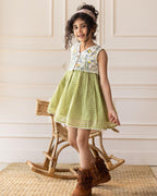 LAAD`S kid in Titalee moss green dress by Laad India, featuring delicate floral embroidery, an eyelet lace bodice, and a gingham checkered dress. A perfect blend of vintage elegance and modern comfort for your little one