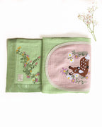 soft green muslin baby dohar featuring hand-embroidered floral details and a bambi nested on a pastel pink patch. Lightweight and breathable, ideal for keeping babies snug and cozy.