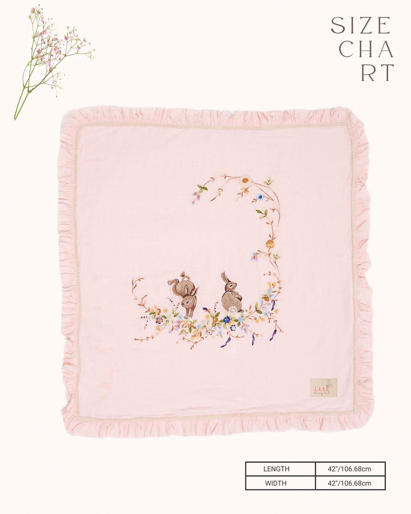 Soft touch of fushia bunny dohar for baby with delicate embroidery featuring two bunnies surrounded by a floral wreath. Made from lightweight, breathable fabric with a satin border—perfect for cozy naps and gentle on baby’s skin.