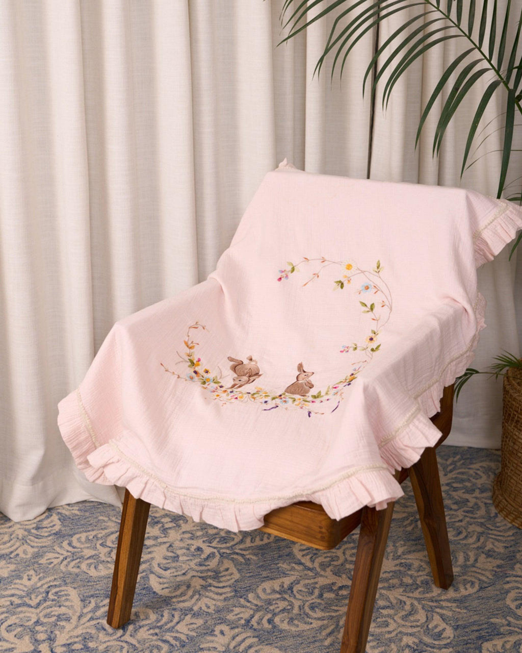 Soft touch of fushia bunny dohar for baby with delicate embroidery featuring two bunnies surrounded by a floral wreath. Made from lightweight, breathable fabric with a satin border—perfect for cozy naps and gentle on baby’s skin.