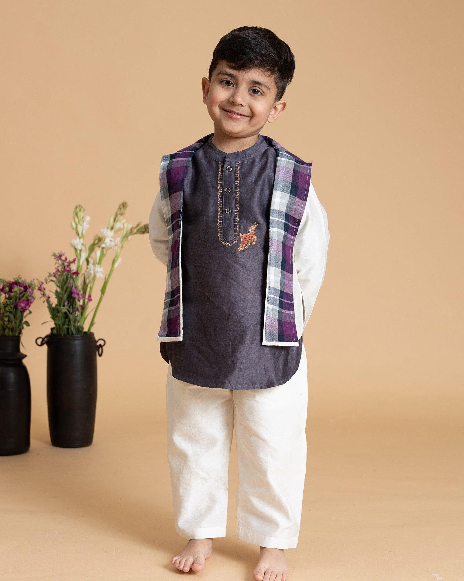 Young boy wearing LAAD India vintage grape kurta with embroidered detail, paired with cream pants and a checkered sleeveless jacket, styled in festive kidswea