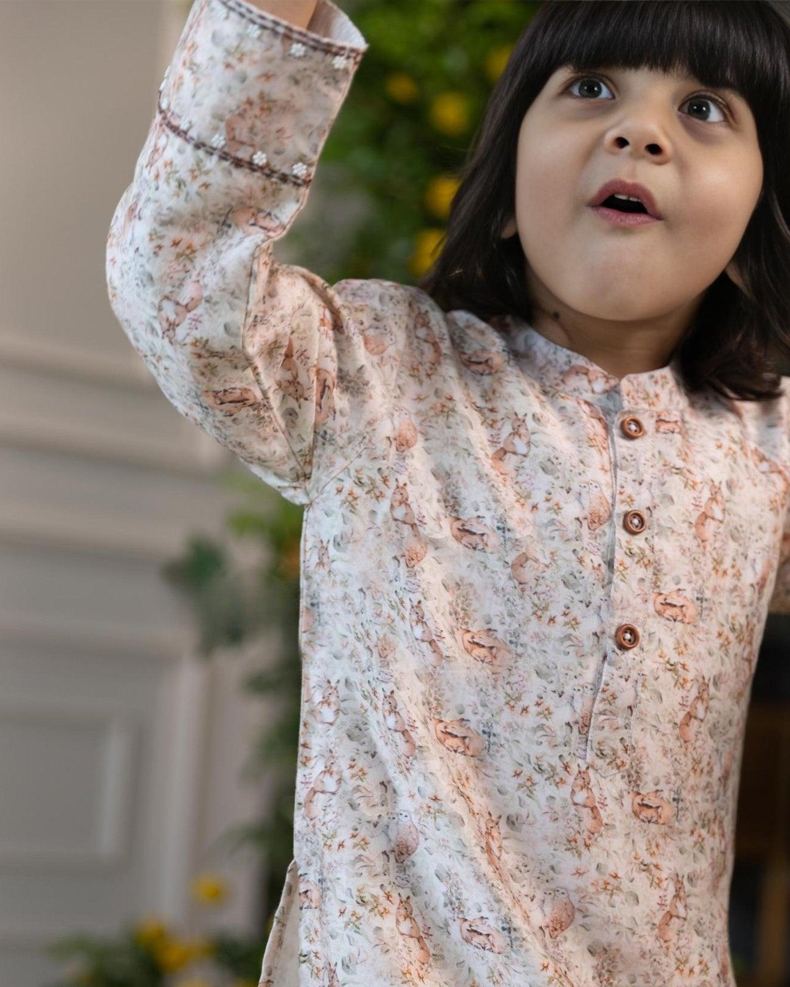 laad`s kid wearing a long-sleeved woodland print kurta with intricate nature-inspired motifs, paired with white pyjama. perfect for festive or special occasions
