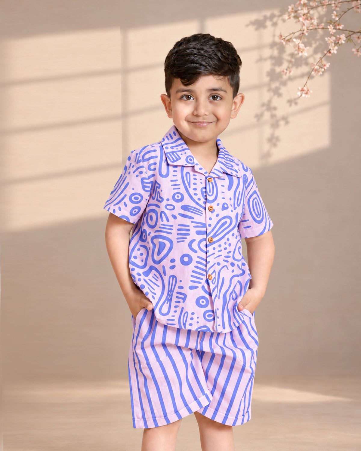 Aline fun print half-sleeve ameba co-ord boy`s holiday shirt and shorts  featuring wooden buttons and stylish strips . A perfect boy`s matching co-ord set and girls co-ord set .
