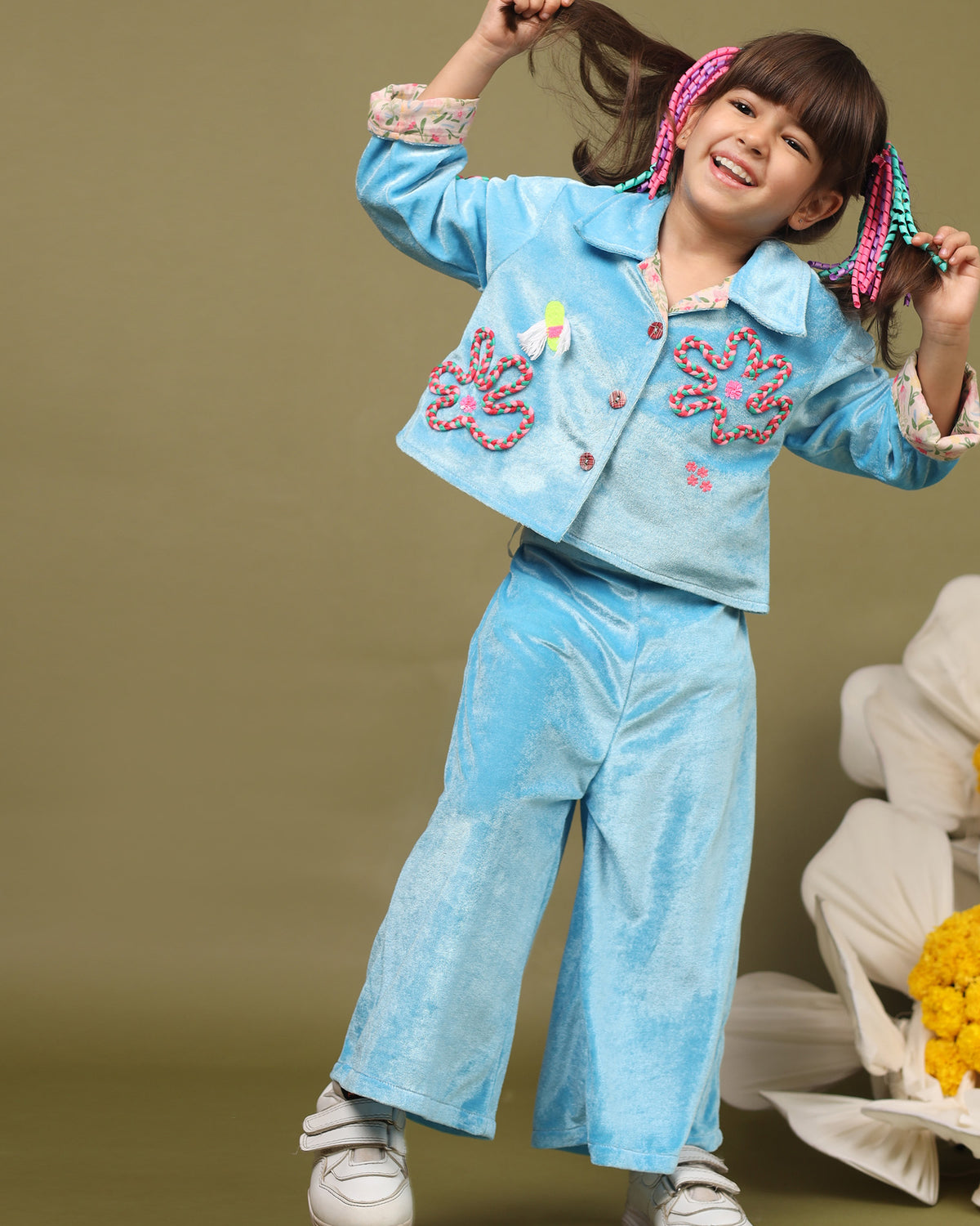 A luxurious baby blue braided velvet co-ord set designed for ultimate comfort and style. The top features intricate hand-embroidered detailing, soft cotton lining, and a front-open button design with full sleeves that can be styled with folded cuffs, making it perfect for keeping little ones cozy and fashionable during winter.

