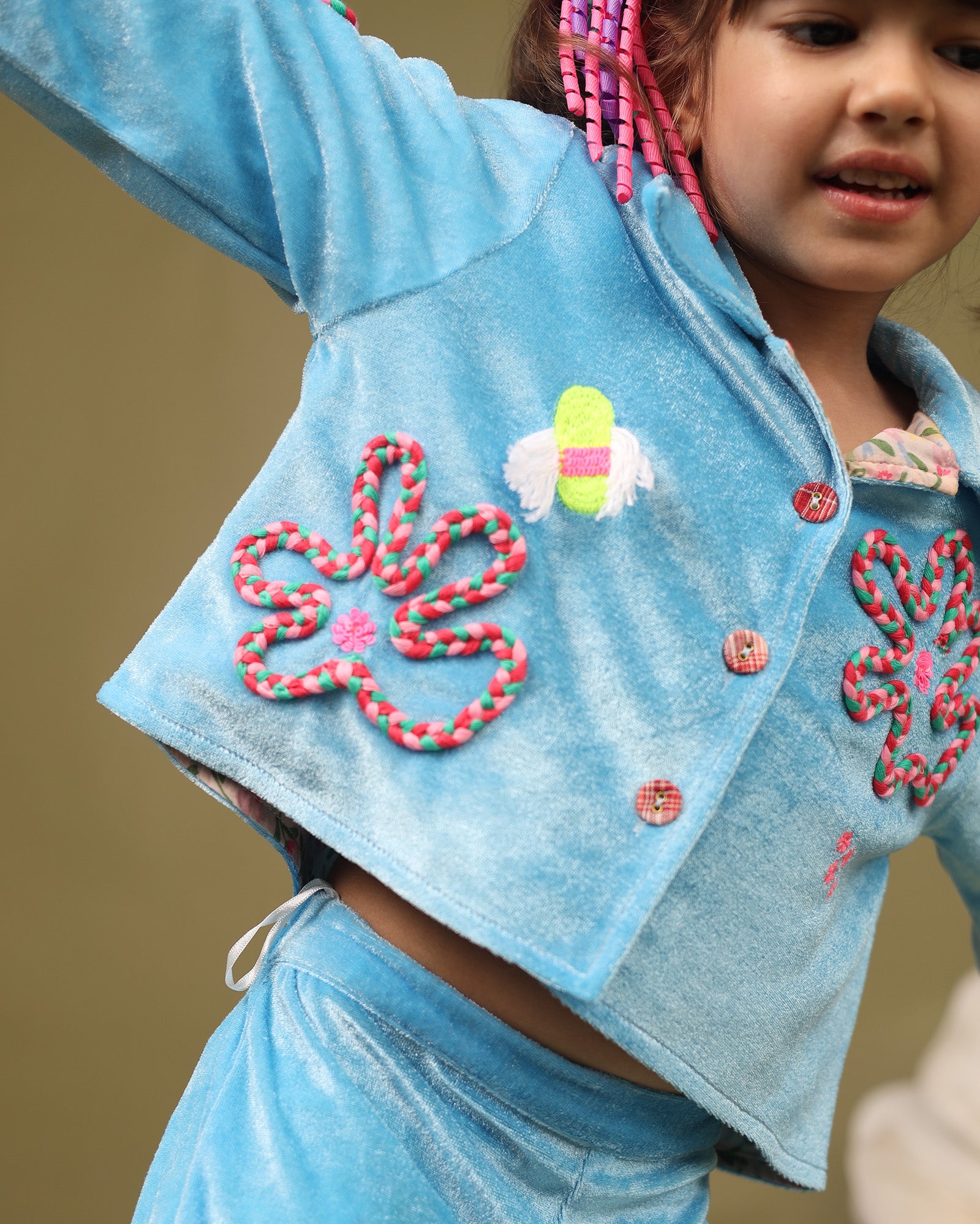 A luxurious baby blue braided velvet co-ord set designed for ultimate comfort and style. The top features intricate hand-embroidered detailing, soft cotton lining, and a front-open button design with full sleeves that can be styled with folded cuffs, making it perfect for keeping little ones cozy and fashionable during winter.