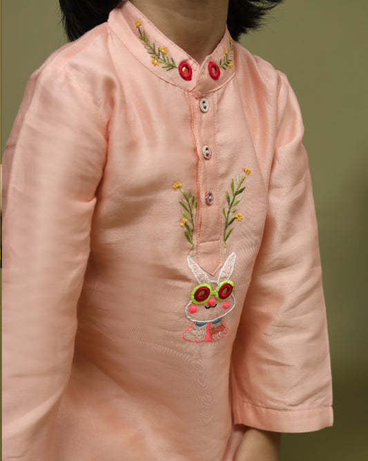 Playful, bright, colorful full-sleeve bandhgala Bunny blush kurta pyjama set. Intricate embroidery featuring bunny blush kurta , shimmering mirror work. Fun buttons add a pop of color. Elastic trousers. Soft cotton lining for comfort by laadindia.com