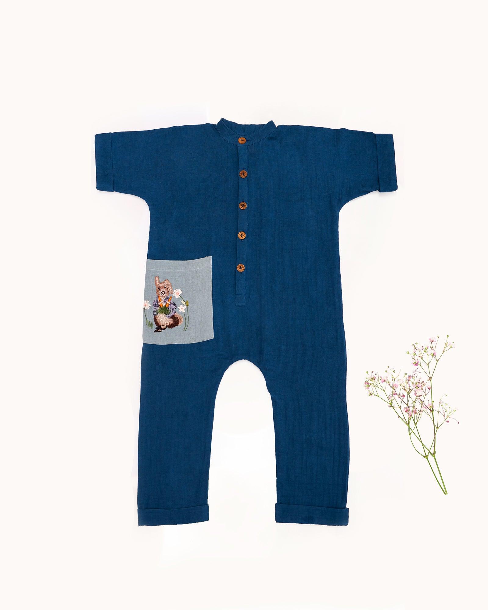 Dress your little one in LAAD's Bunny Jumpsuit, featuring a bandhgala collar, wooden buttons, and hand-embroidered Peter Rabbit details. Elegant, playful, and travel-ready!