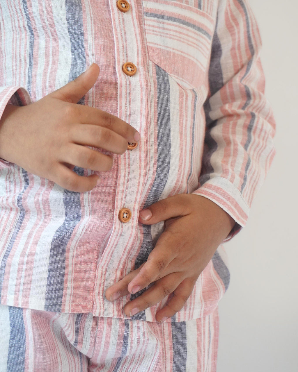 LAAD`S boy wearing candy stipe co-ord set, classic shirt with bermuda shorts.