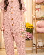 Laad`s child is wearing the adorable daisy onesie boasts a comfy round neck & wooden button front. A spacious pocket is adorned with charming hand-embroidered flowers & butterflies. Super soft fabric & a relaxed fit keep your little one happy & comfy all trip long!