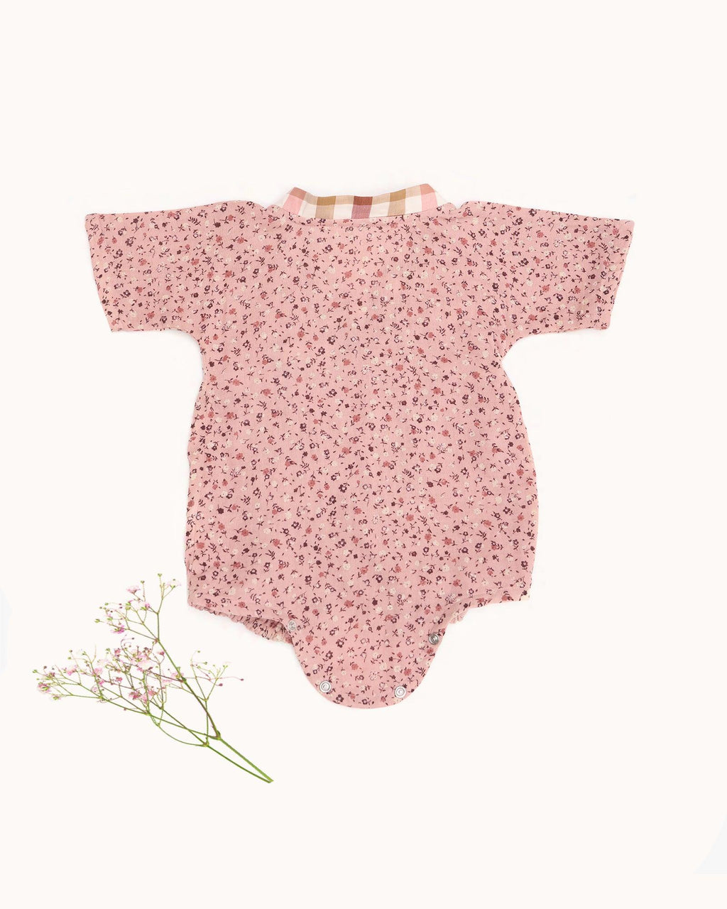 Baby romper size chart by LAAD India – pink floral wrap-style bubble romper with checkered neckline. Adjustable straps for comfort . This baby romper is perfect everyday wear