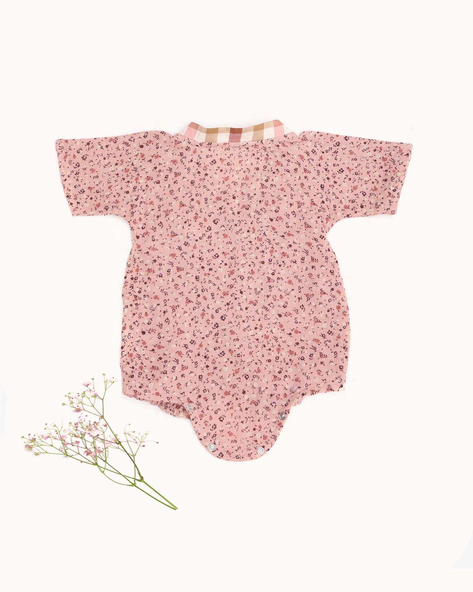 Baby romper size chart by LAAD India – pink floral wrap-style bubble romper with checkered neckline. Adjustable straps for comfort . This baby romper is perfect everyday wear
