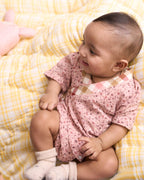 Baby cotton romper size chart by LAAD India – pink floral wrap-style bubble romper with checkered neckline. Adjustable straps for comfort . This baby romper is perfect everyday wear