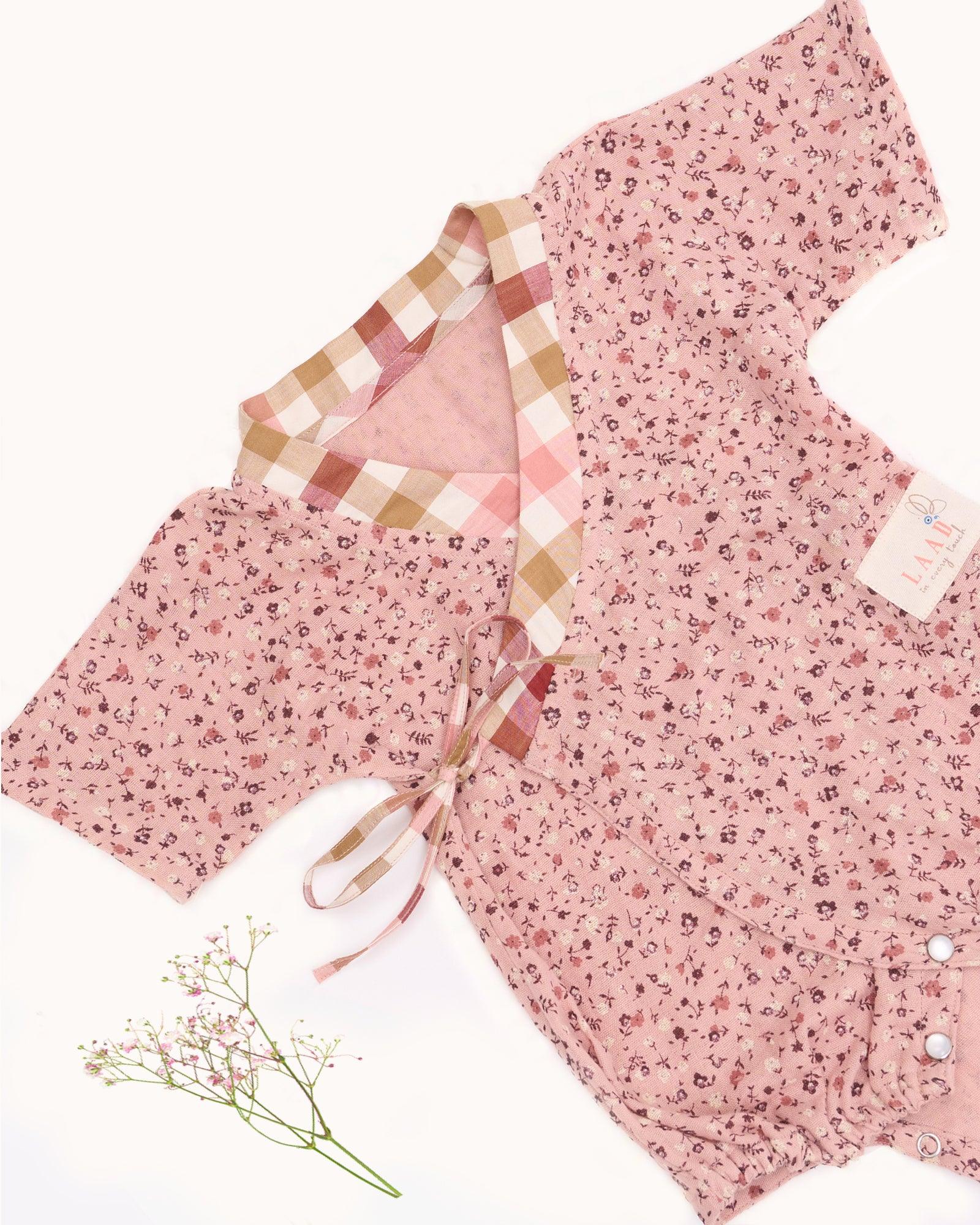 Baby cotton romper size chart by LAAD India – pink floral wrap-style bubble romper with checkered neckline. Adjustable straps for comfort . This baby romper is perfect everyday wear