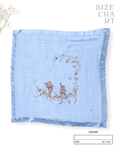 Soft fairytale blue bunny dohar for baby with delicate embroidery featuring two bunnies surrounded by a floral wreath. Made from lightweight, breathable fabric with a satin border—perfect for cozy naps and gentle on baby’s skin.