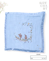 Soft fairytale blue bunny dohar for baby with delicate embroidery featuring two bunnies surrounded by a floral wreath. Made from lightweight, breathable fabric with a satin border—perfect for cozy naps and gentle on baby’s skin.