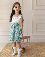 Flora dress has embroidered bunnies hop on the hand-stitched neckline. Cotton lace yoke adds charm. Breezy & comfy for warm days. Easy click-button back. SummerStyle