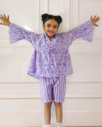 Laad`s girl  wearing a lilac kimono ameba co-ord set with abstract print top and striped shorts, stylish summer kidswear from LAAD India.
