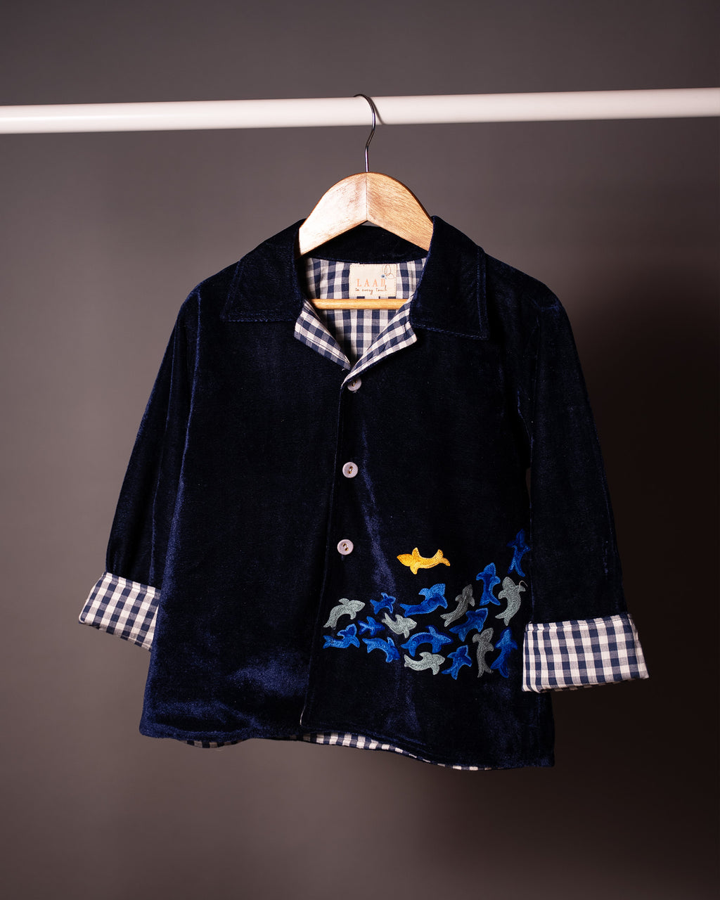 Midnite Shoal co-ord set by LAADINDIA.com, featuring a child dressed in a navy blue velvet co-ord with floating fish embroidery, front-open top with contrast check cuffs, and matching trousers for winter festive wear.