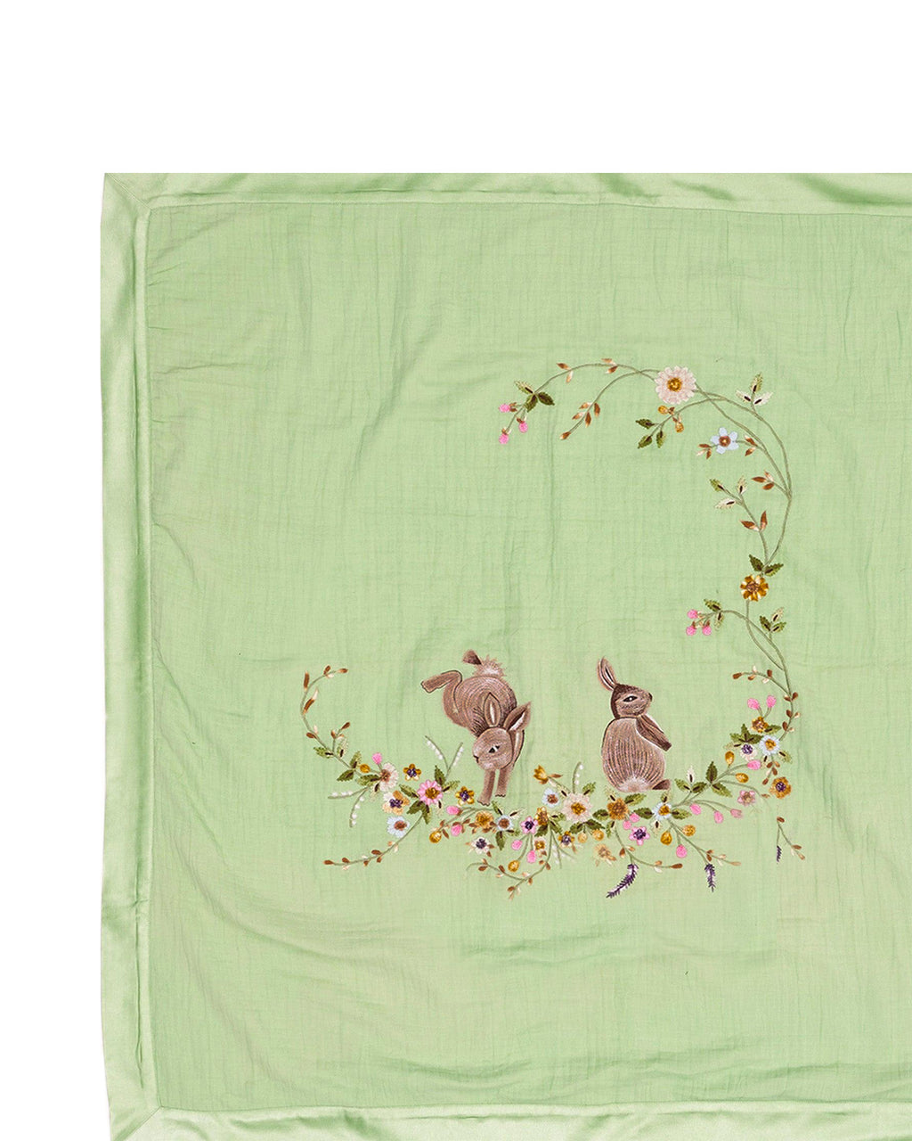 Soft green baby dohar with delicate embroidery featuring two bunnies surrounded by a floral wreath. Made from lightweight, breathable fabric with a satin border—perfect for cozy naps and gentle on baby’s skin.