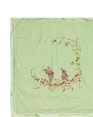 Soft green baby dohar with delicate embroidery featuring two bunnies surrounded by a floral wreath. Made from lightweight, breathable fabric with a satin border—perfect for cozy naps and gentle on baby’s skin.