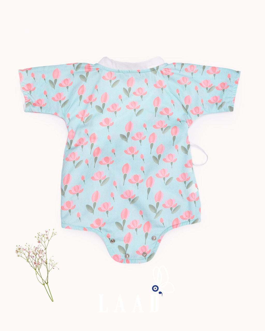 happy toddler Laad`s girl wearing a mint green kimono-style romper with pink tulip floral print .