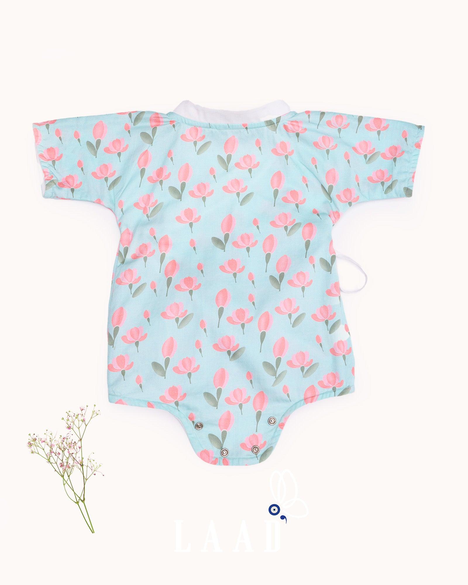 happy toddler Laad`s girl wearing a mint green kimono-style romper with pink tulip floral print .