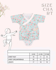 happy toddler Laad`s girl wearing a mint green kimono-style romper with pink tulip floral print .