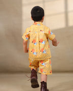 A cheerful Laad`s co-ord set nanha heeran in a vibrant yellow hue, featuring playful deer and geometric prints, a collared button-down shirt, and matching shorts.