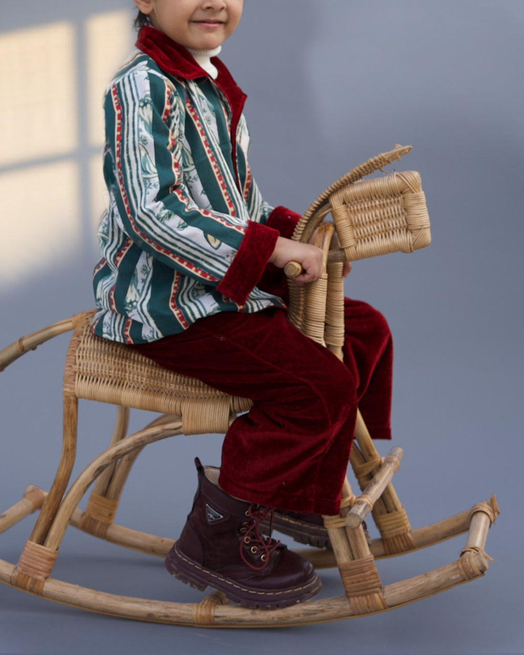 redvelvet co-ord set by LAADINDIA.com, featuring a child dressed in a red velvet co-ord with  embroidery, front-open top with contrast check cuffs, and matching trousers for winter occasion wear.