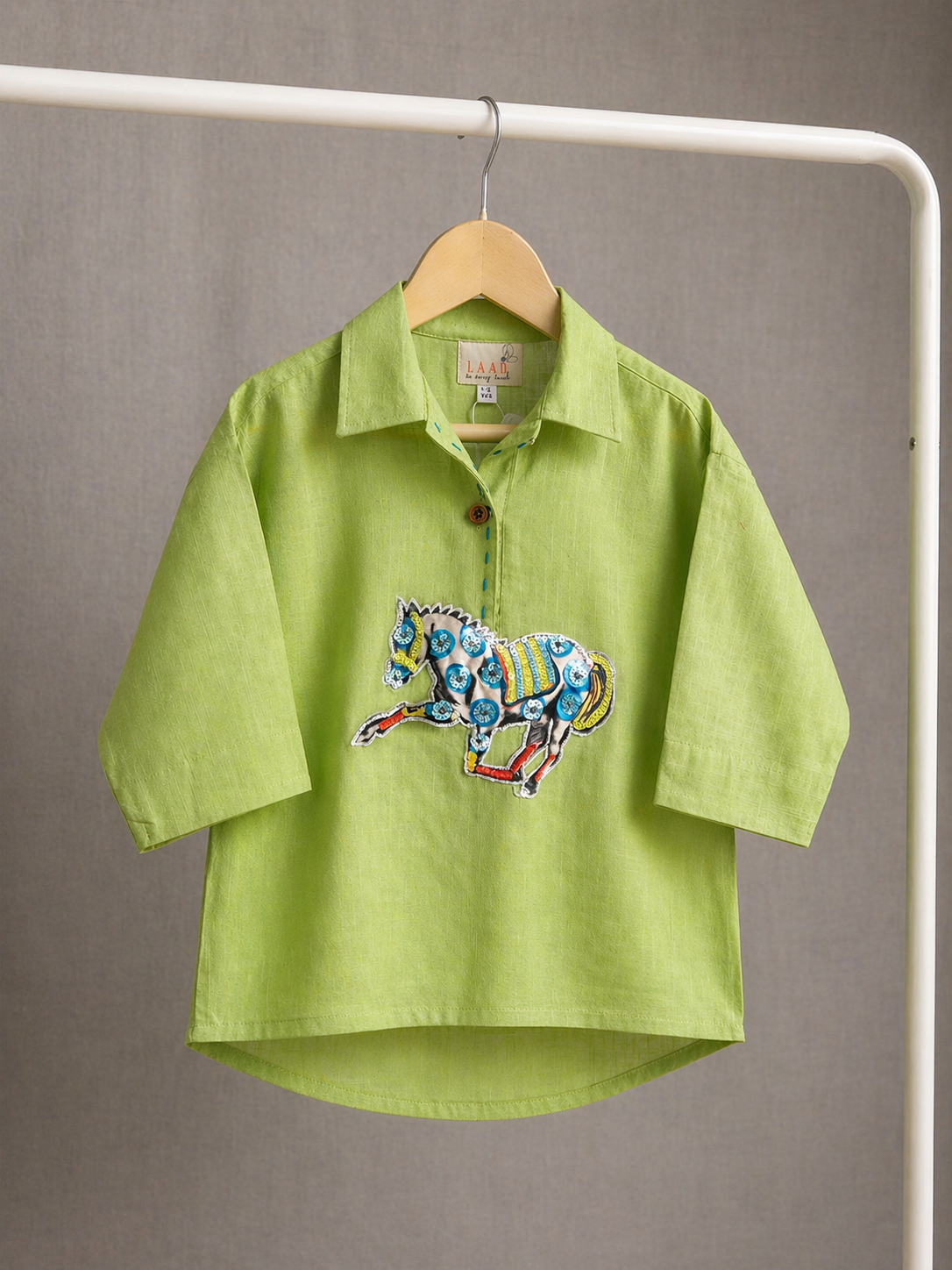 Lime green boys co-ord set with embroidered horse motif and vibrant striped pants by LAAD.