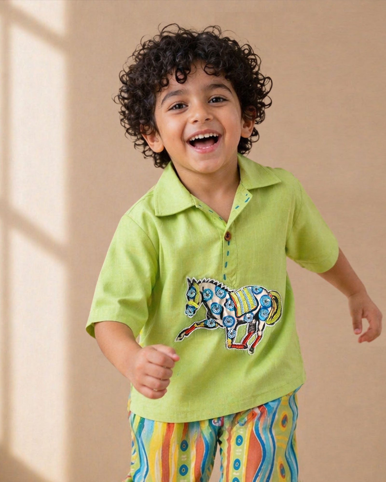 Lime green boys co-ord set with embroidered horse motif and vibrant striped pants by LAAD.