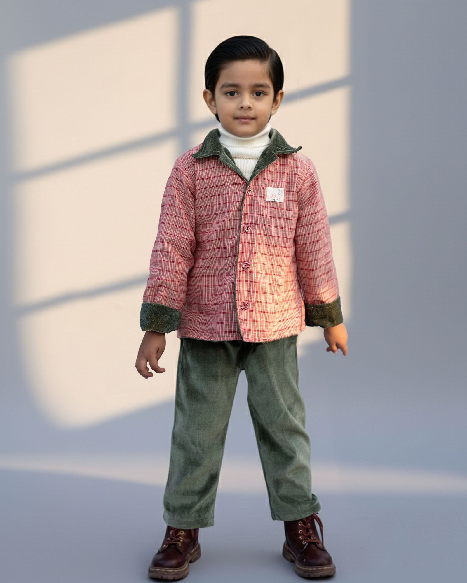 sage shoal co-ord set by LAADINDIA.com, featuring a child dressed in a navy blue velvet co-ord with floating fish embroidery, front-open top with contrast check cuffs, and matching trousers for winter festive wear.