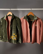 sage shoal co-ord set by LAADINDIA.com, featuring a child dressed in a navy blue velvet co-ord with floating fish embroidery, front-open top with contrast check cuffs, and matching trousers for winter festive wear.