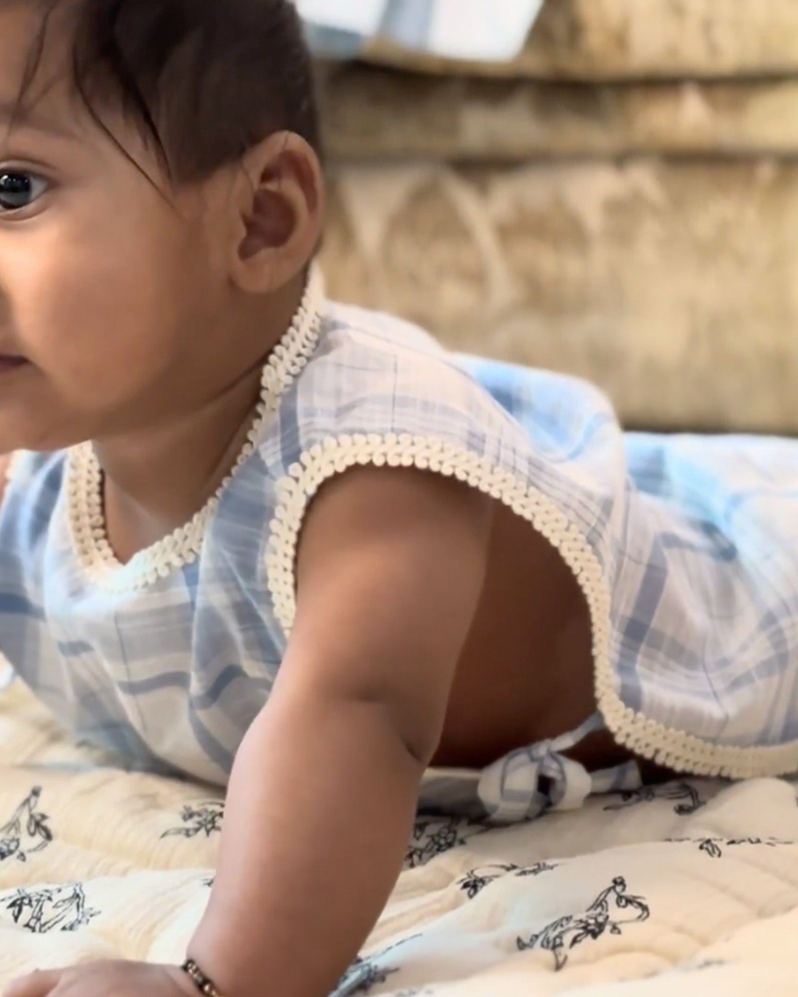 baby in LAAD`S  soft blue plaid jhabla featuring delicate lace trim and a floral pocket, paired with diaper cover