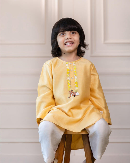 Laad's sunshine bambani new Kurta Pyjama sets redefine sophistication! ✨ Two-piece elegance in silk chanderi features a comfy round neck, full sleeves, and a graceful knee-length hem. Delicate beadwork on the placket adds a touch of shimmering glamour.  3-piece set with a dazzling kurta, comfy pyjama, & checkered jacket. Shine bright at any function