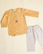 Elegant yellow kurta pyjama set for kids by Laad India, featuring delicate beadwork, intricate hand embroidery of a bambi, and a soft cotton lining for ultimate comfort. Perfect ethnic wear for festive occasions and celebrations