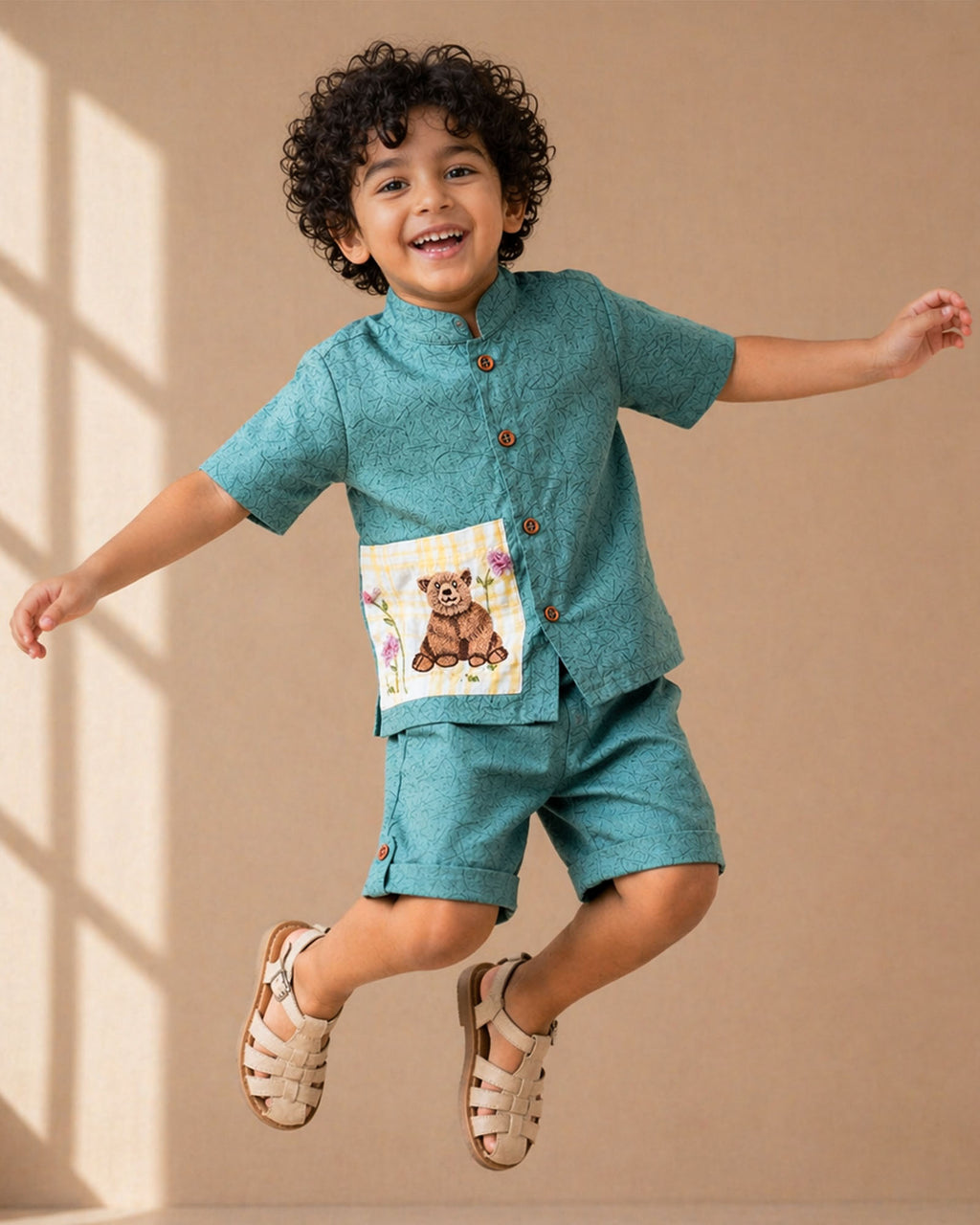 Ted Bagh Co-ord by LAAD — boys cotton co-ord  linen set featuring a mandarin collar shirt with wooden button closure, handcrafted bear appliqué pocket with floral embroidery, and matching tailored shorts.