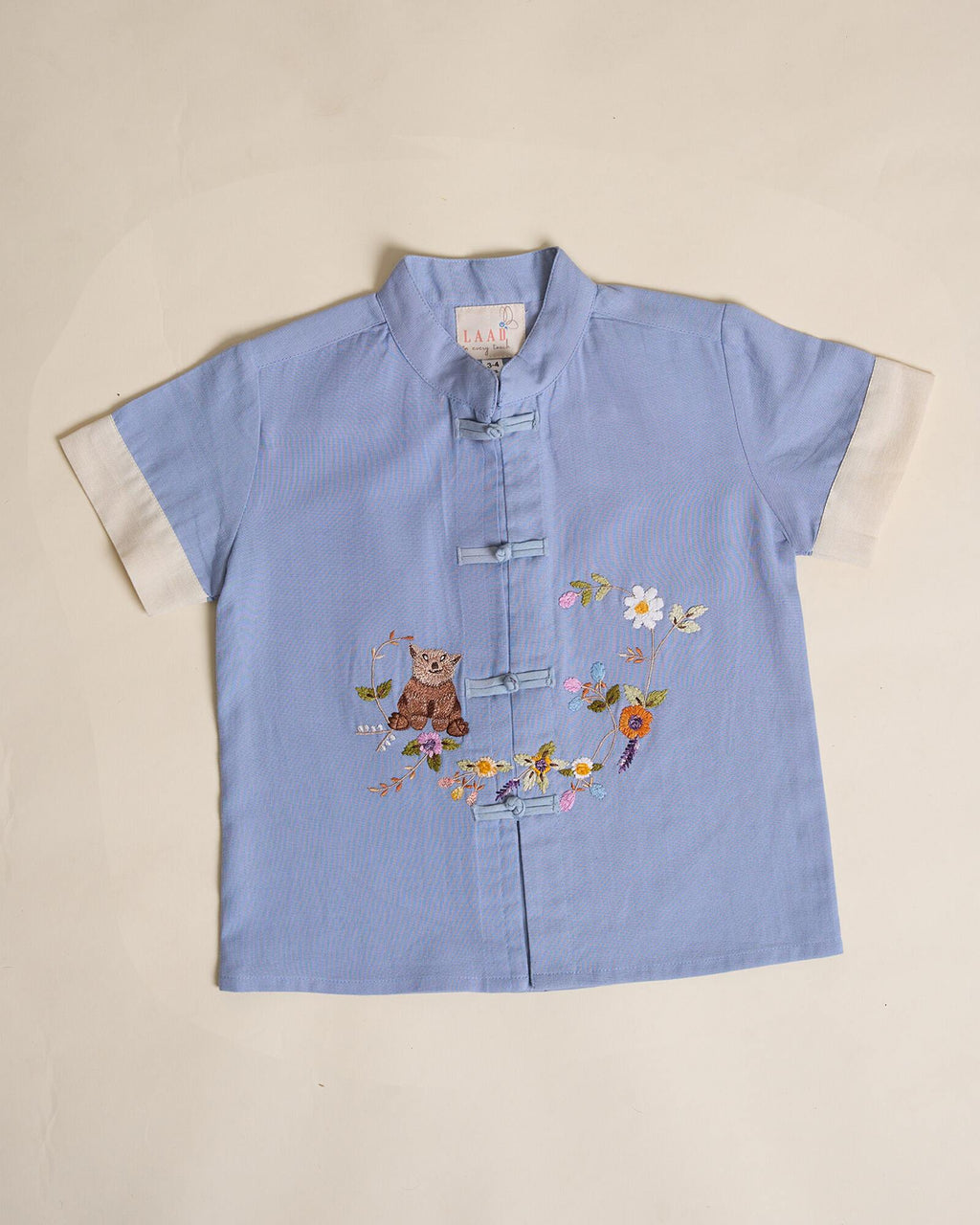 Keep it cool with our Blue Ted Summer Shirt, crafted from breathable fabric for comfort. A mandarin collar, loop buttons, and teddy embroidery add playful charm.