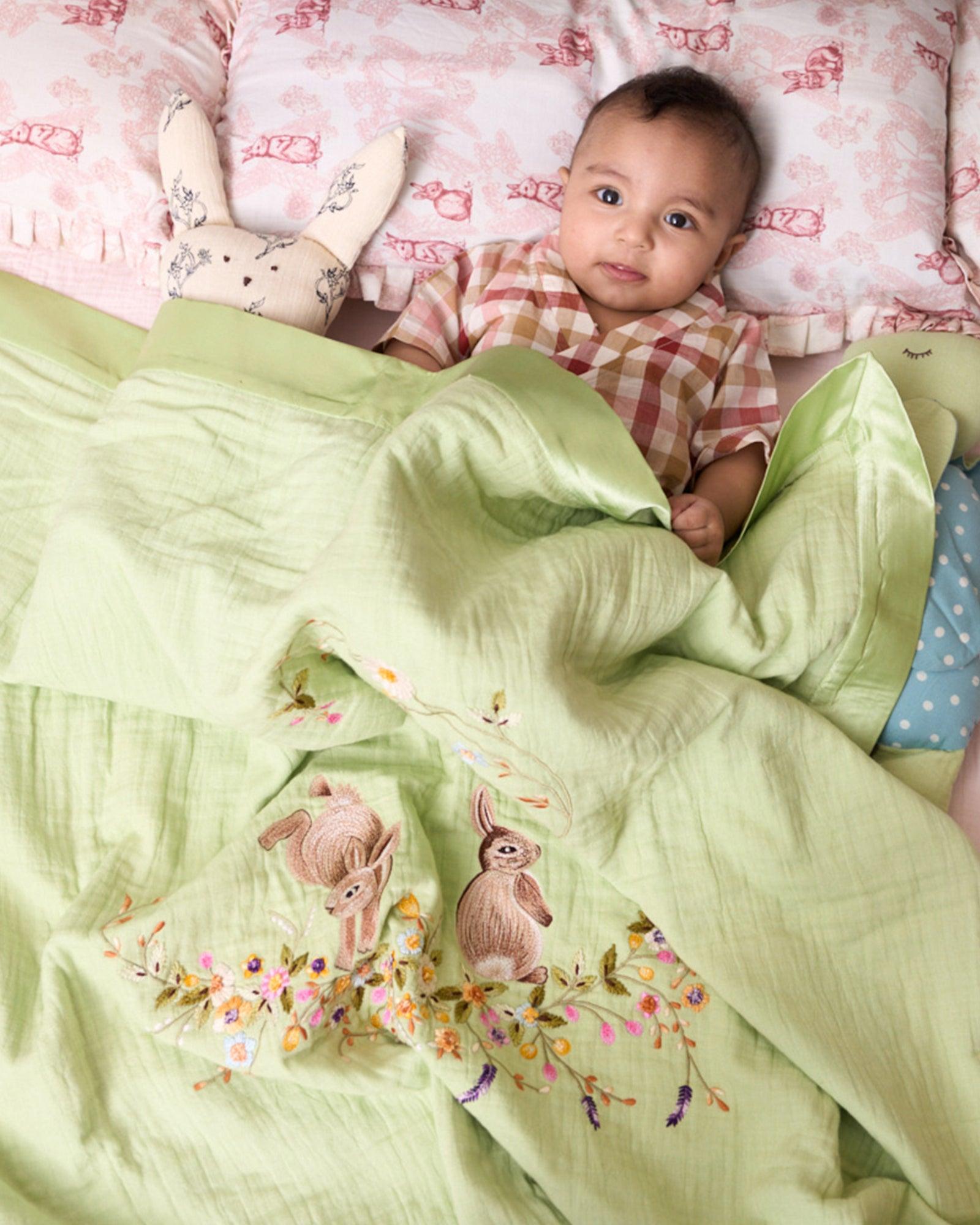 Hand-stitched Bambi dohar: nestled in flowers. 100% cotton muslin for ultimate softness & sleep.