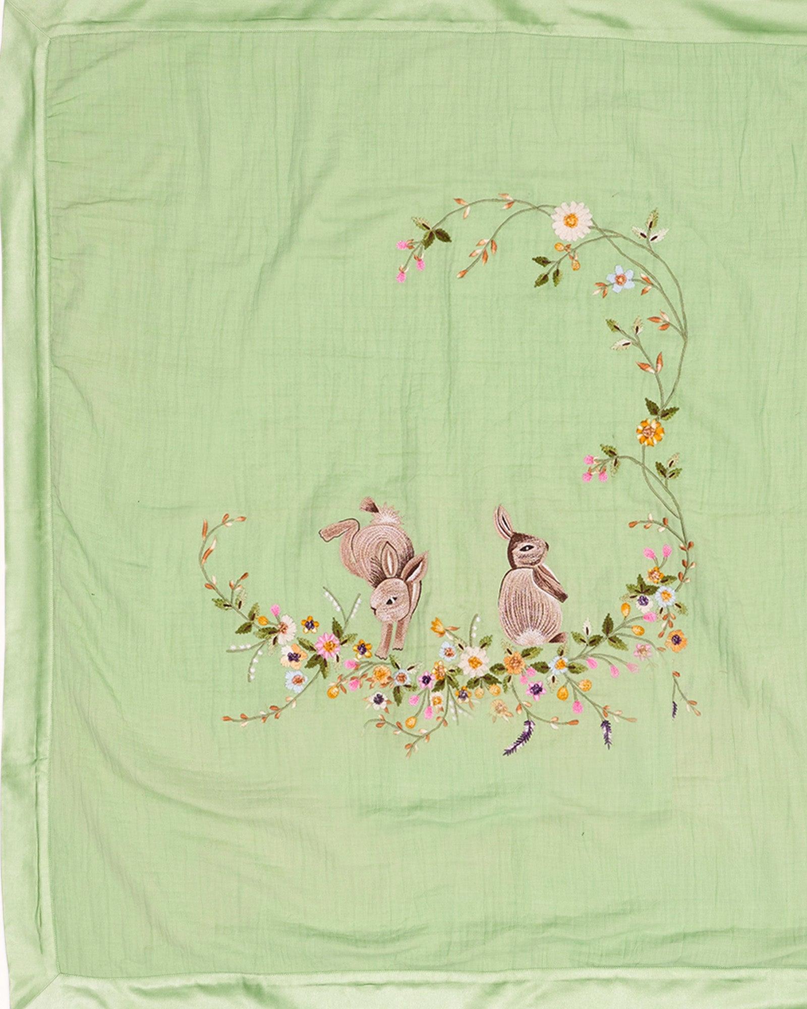 Hand-stitched Bambi dohar: nestled in flowers. 100% cotton muslin for ultimate softness & sleep.