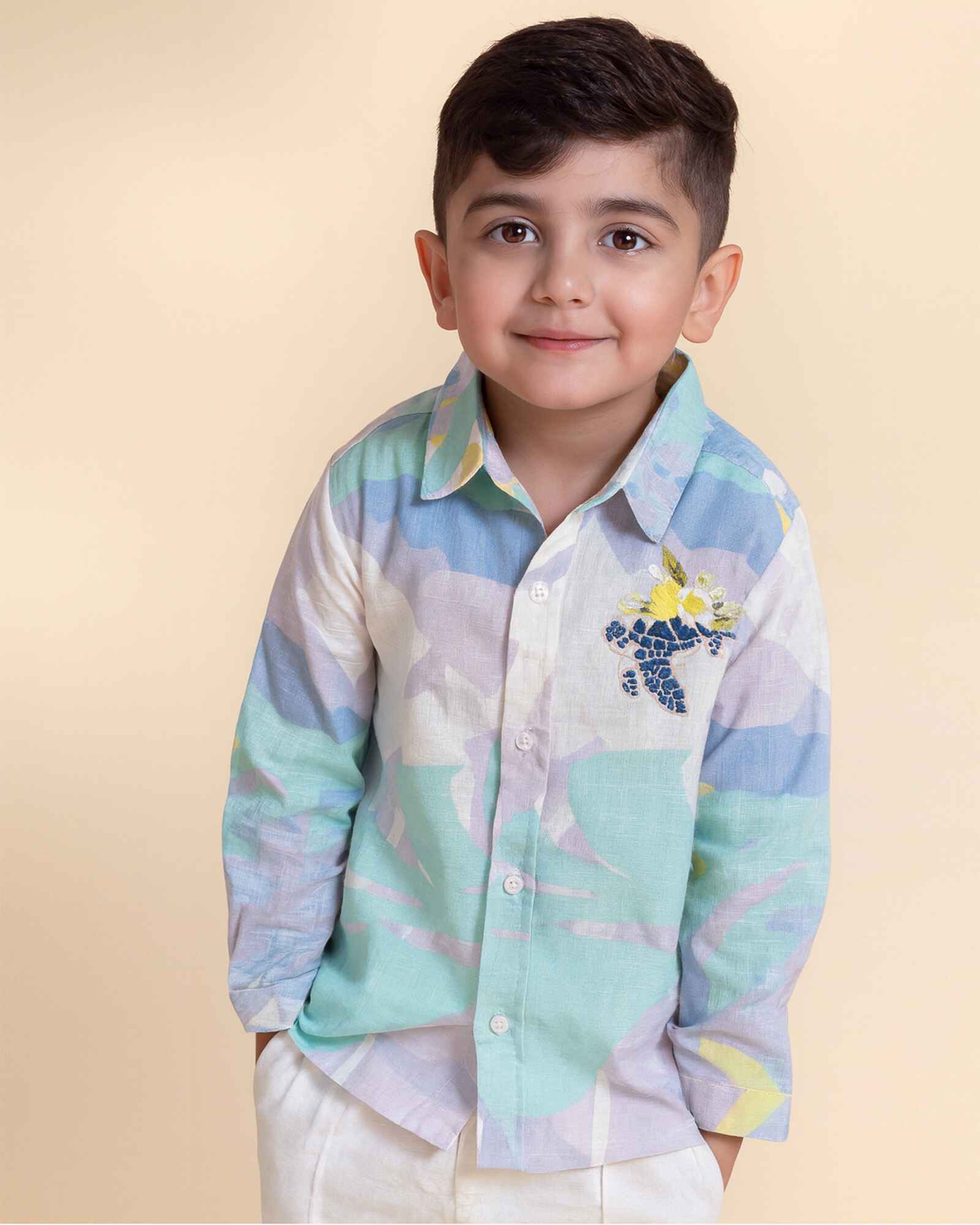 Make a splash with this ocean-themed kids’ turtle shirt featuring a vibrant sea print and hand-embroidered turtle. Breathable cotton, full sleeves, and timeless style—perfect for sunny days.