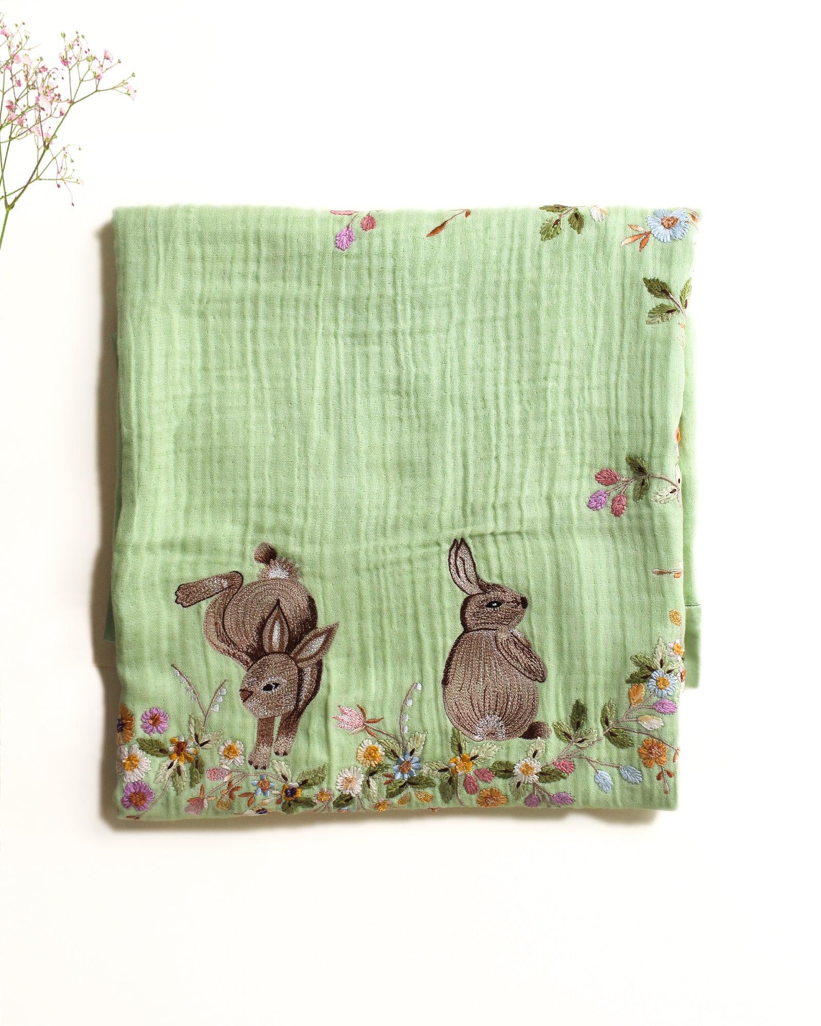 Hand-stitched Bambi dohar: nestled in flowers. 100% cotton muslin for ultimate softness & sleep.