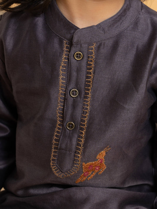 Young boy wearing LAAD India vintage grape kurta with embroidered detail, paired with cream pants and a checkered sleeveless jacket, styled in festive kidswea