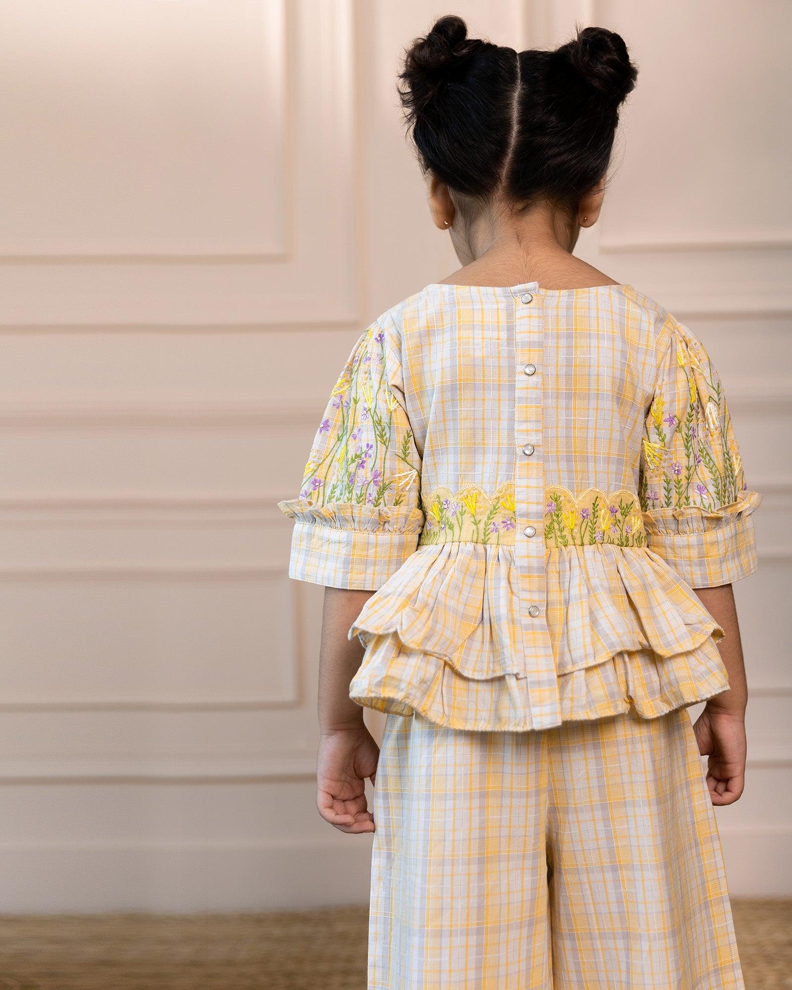 Exquisite sunshine checkered peplum co-ord with beautifully Hand-embroidered belt & puffed sleeves add playful charm