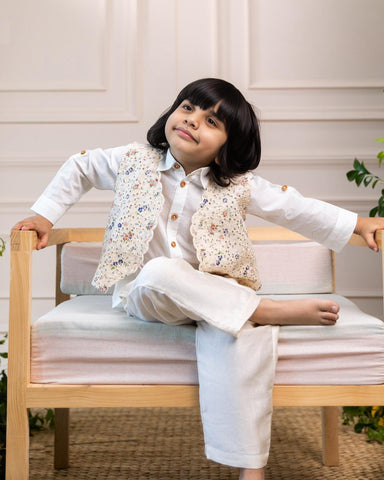 laad`s kid in Classic white cotton shirt  paired with a 100% cotton waistcoat with butterfly embroidery at the back . Perfect boy`s party wear