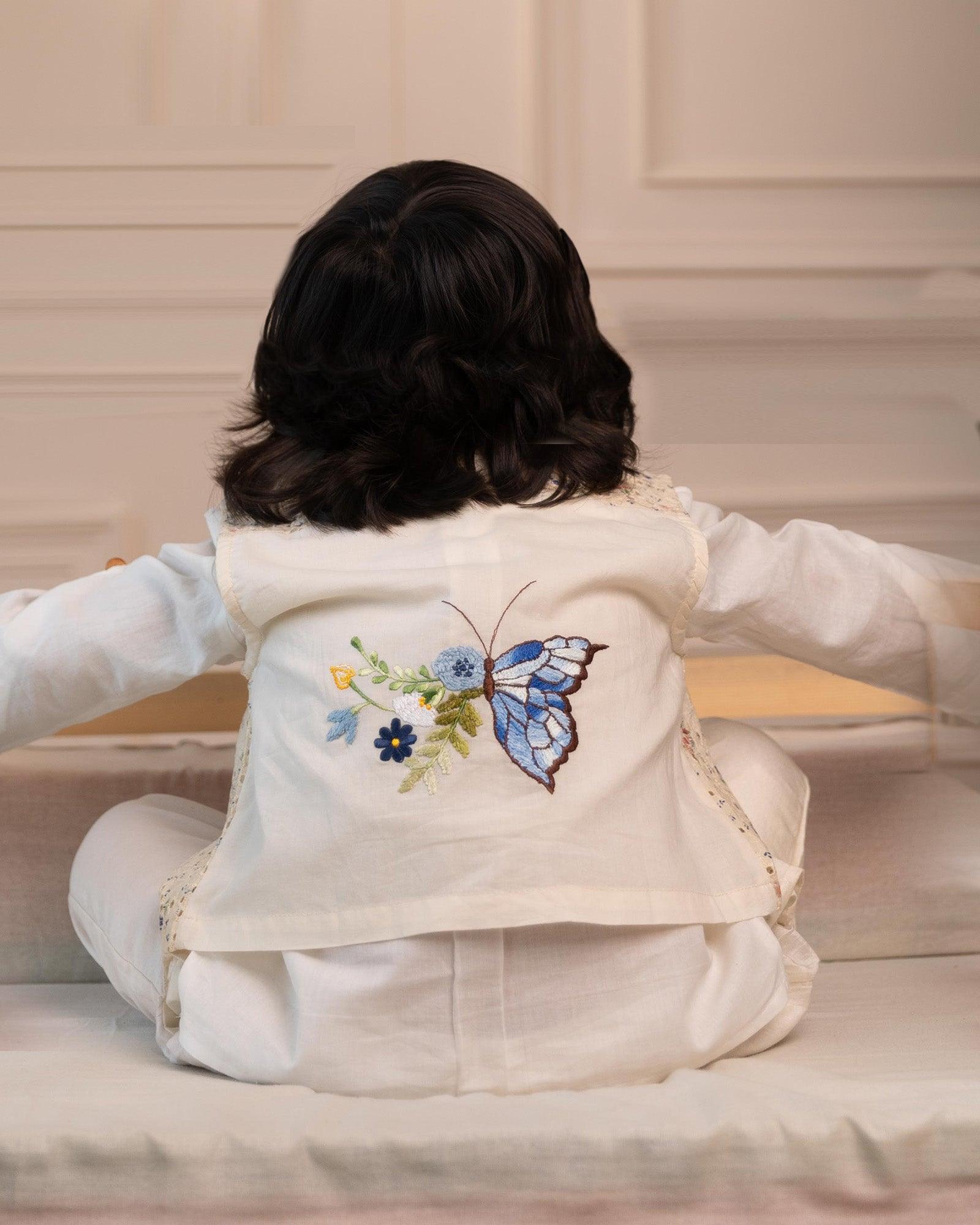 3-piece white ball suit set from laadindia ! Crisp cotton shirt, 100% cotton waistcoat with intricate details & silk Chanderi pyjama. Hand-embroidered, titalee motif adds charm.